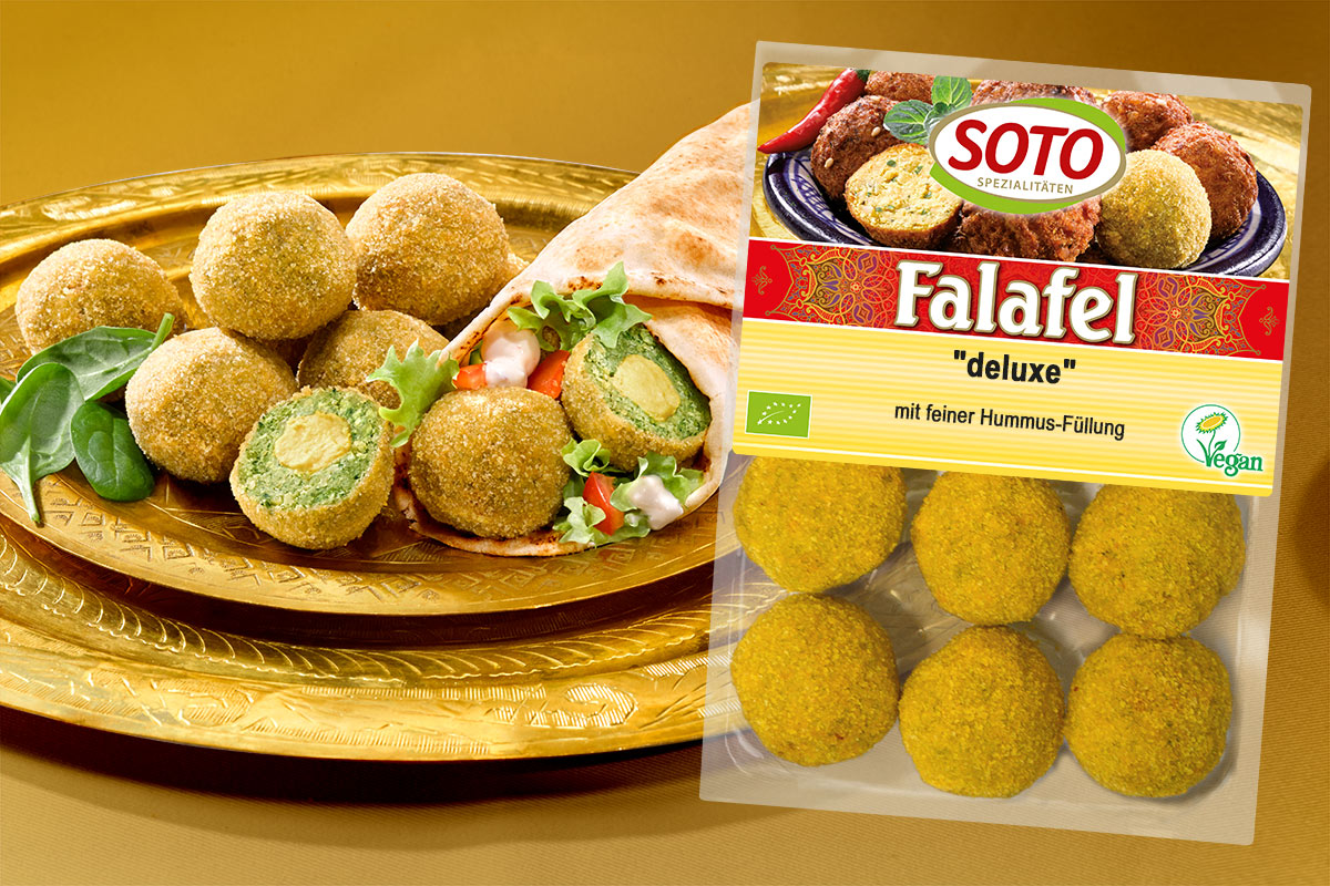 Packung SOTO Falafel deluxe neben Falafelbällchen mit Hummus-Füllung auf goldenem Tablett
